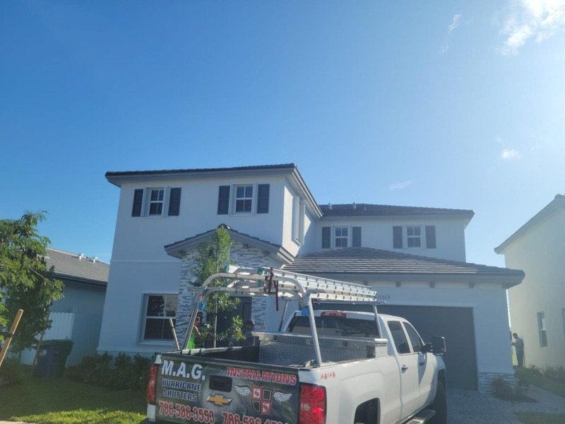 M.A.G. Hurricane Shutters installation truck at a Miami job site